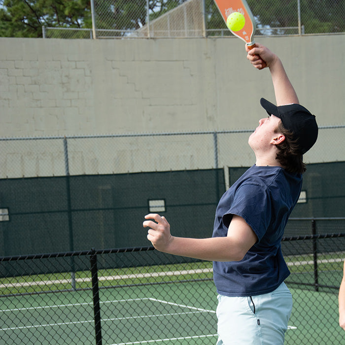 Caucasian Male returning a hit using the Dilly Co Carbon Fiber Pickleball Paddle