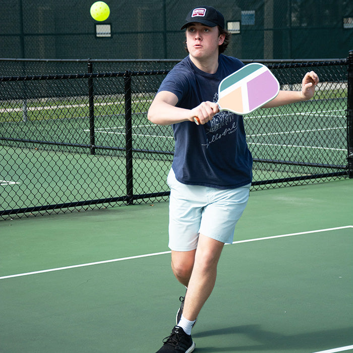 Caucasian Male returning a hit using the Dilly Co Carbon Fiber Pickleball Paddle