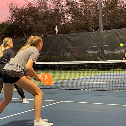 Female using Carbon Fiber Pickleball paddle awaiting serve